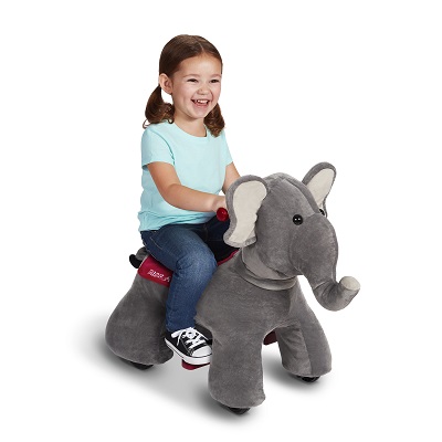 girl laughing while riding the grey electric ride-on elephant toy